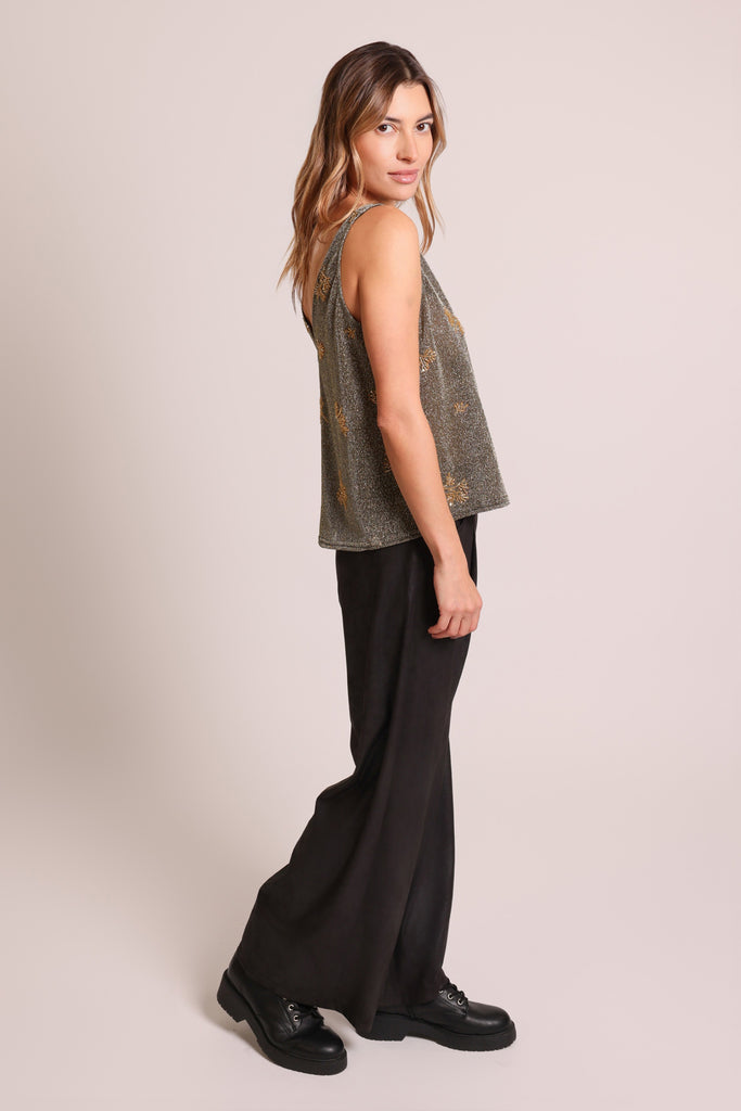 Side shot of model wearing a black and silver glittery gold beaded sleeveless V-neck vest top.