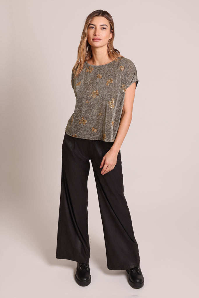 Front shot of model wearing a black and silver glitter gold beaded short sleeve slouch shirt.
