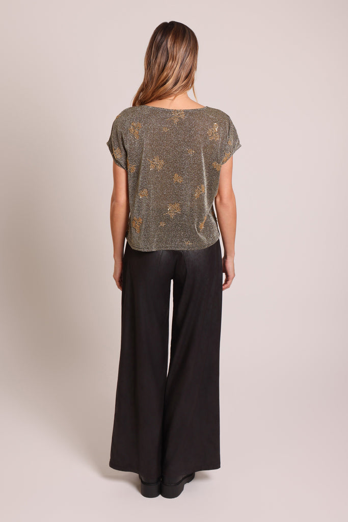 Back shot of model wearing a black and silver glitter gold beaded short sleeve slouch shirt.