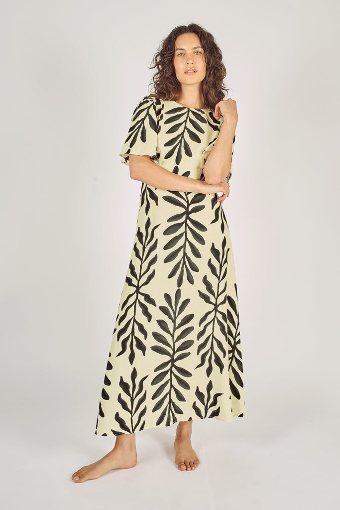 Another Front Model Shot of Cream and Black Leaf Print Trumpet Sleeve Fit and Flare Maxi Dress.