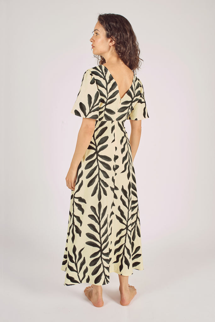 Back Model Shot of Cream and Black Leaf Print Trumpet Sleeve Fit and Flare Maxi Dress.