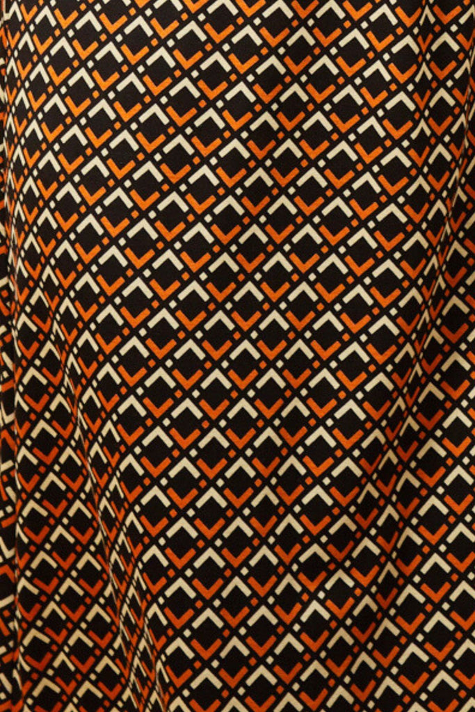 Close Up of Black and Orange Geometric Print Fabric