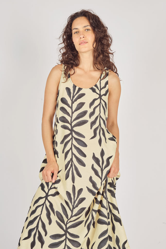 Close Up Front Model Shot of Cream and Black Leaf Print Sleeveless Midi Dress with Pockets.