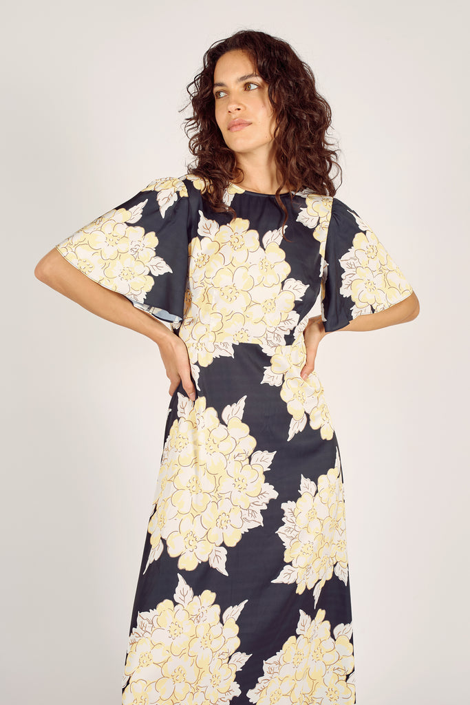 Close Up Front Model Shot of Navy Blue and Cream Floral Trumpet Sleeve Fit and Flare Maxi Dress.