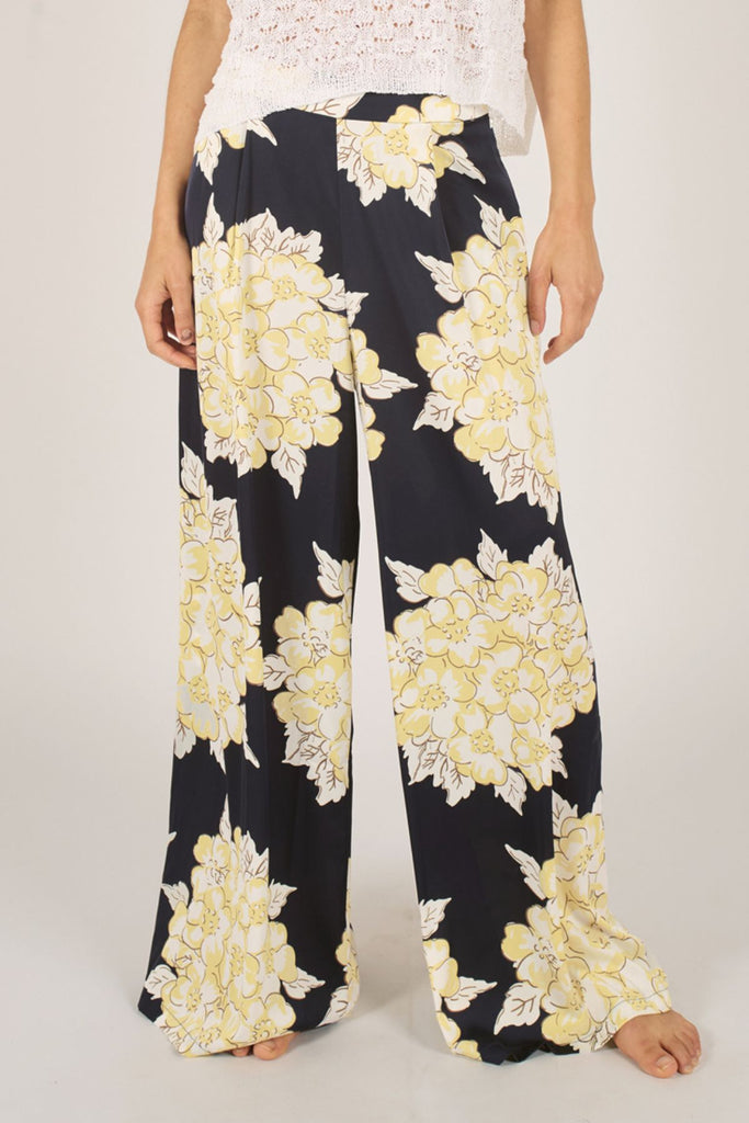 Close Up Front Model Shot of Navy Blue and Cream Floral Wide Leg Women's Trousers.