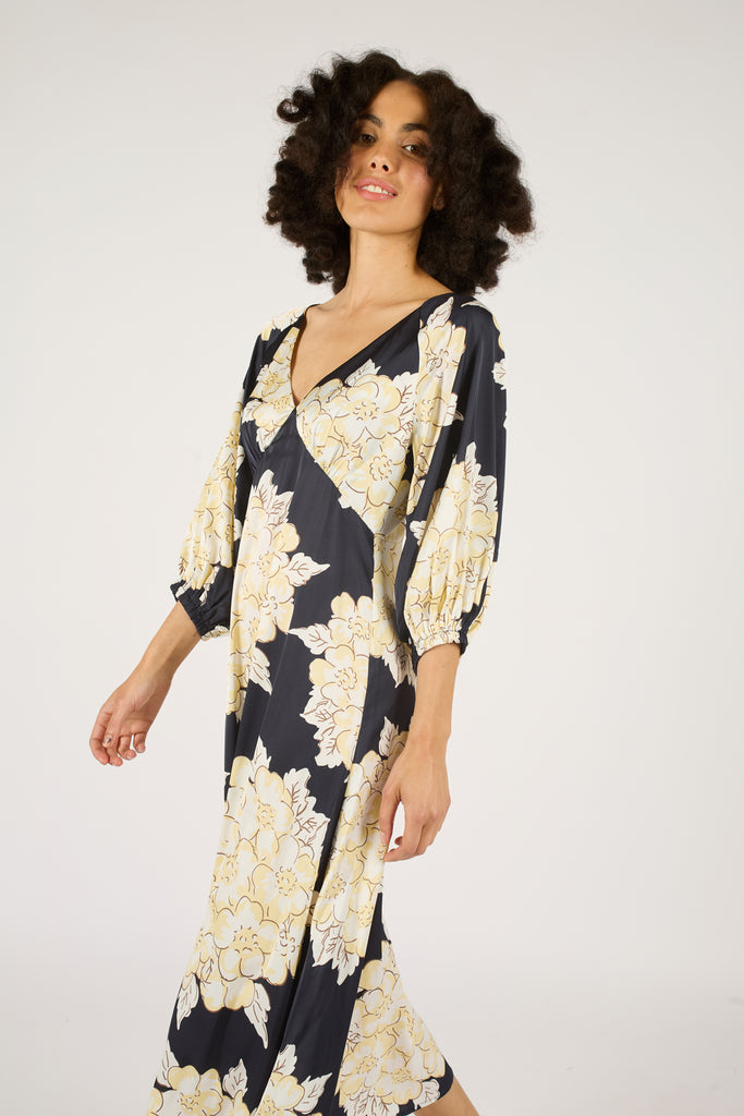 Close Up Side Model Shot of Navy Blue and Cream Floral V-Neck Three Quarter Sleeve Midi Dress.