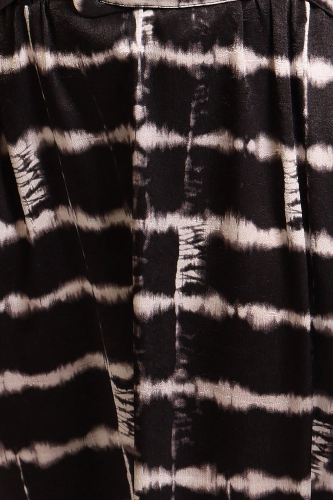 Swatch for black and white brick wall print dress fabric.