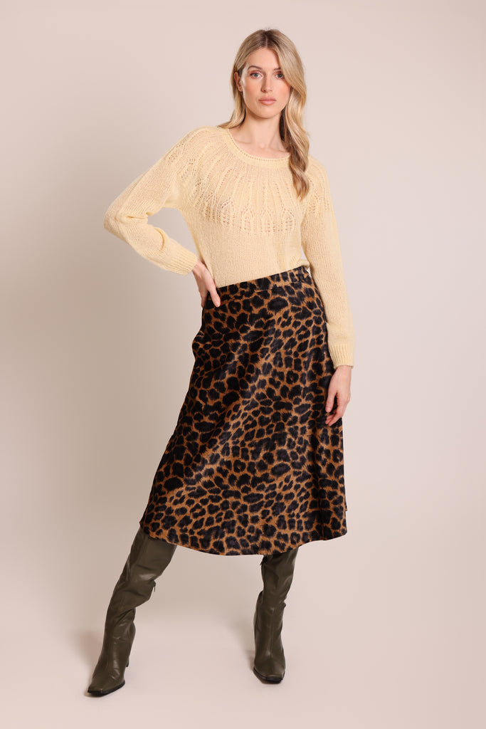 Front shot of model wearing a cream knitted long sleeve round neck jumper.