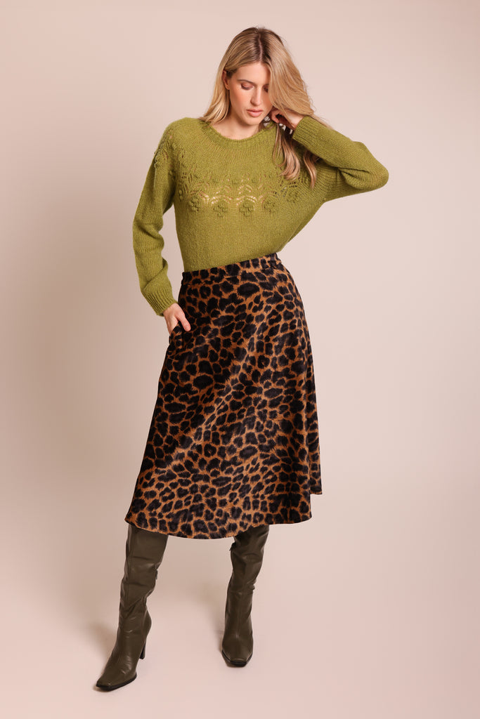 Front shot of model wearing a green knitted long sleeve round neck jumper.