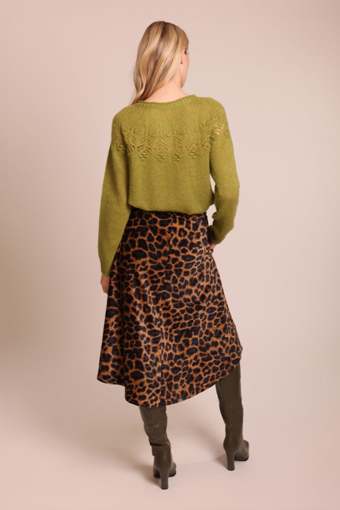 Back shot of model wearing a green knitted long sleeve round neck jumper.