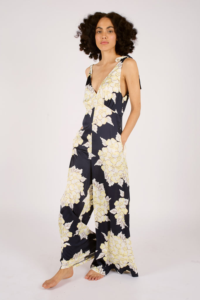 Side Model Shot of Navy Blue and Cream Floral Tie trap Wide Leg Women's Jumpsuit.